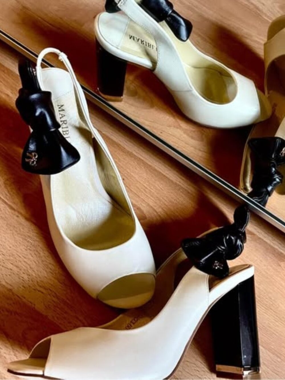 Mariblue brand new Leather stiletto sandals ivory, with black leather bow. Gold